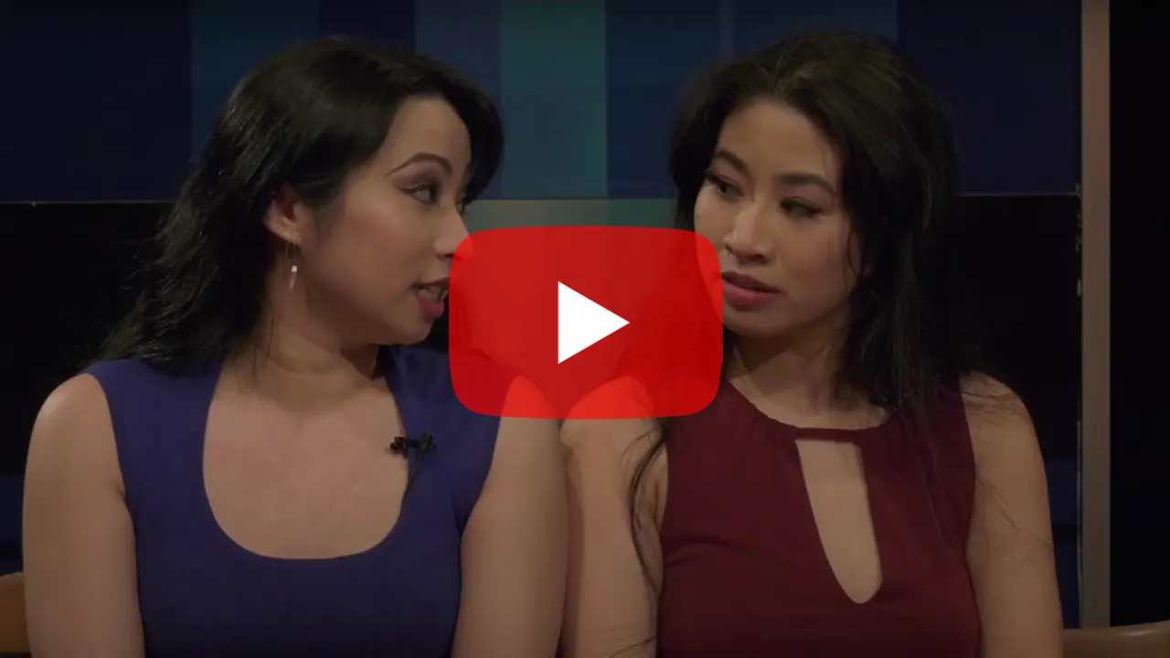Video thumbnail featuring Jacqueline and Stephanie Ko, disabled Chinese-Canadian women wearing blue and red tops, in the middle of an interview