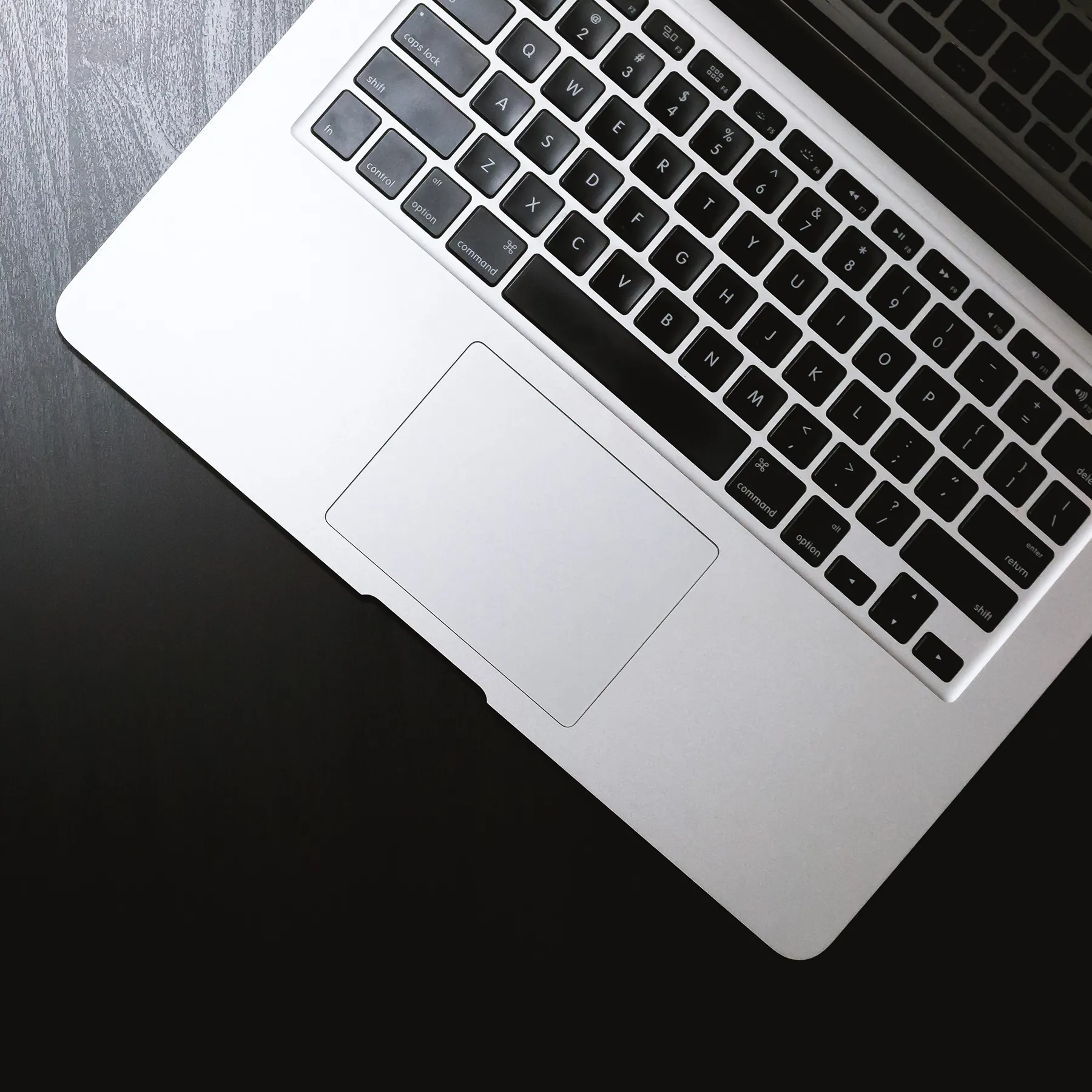 Closeup of a laptop keyboard on a dark table