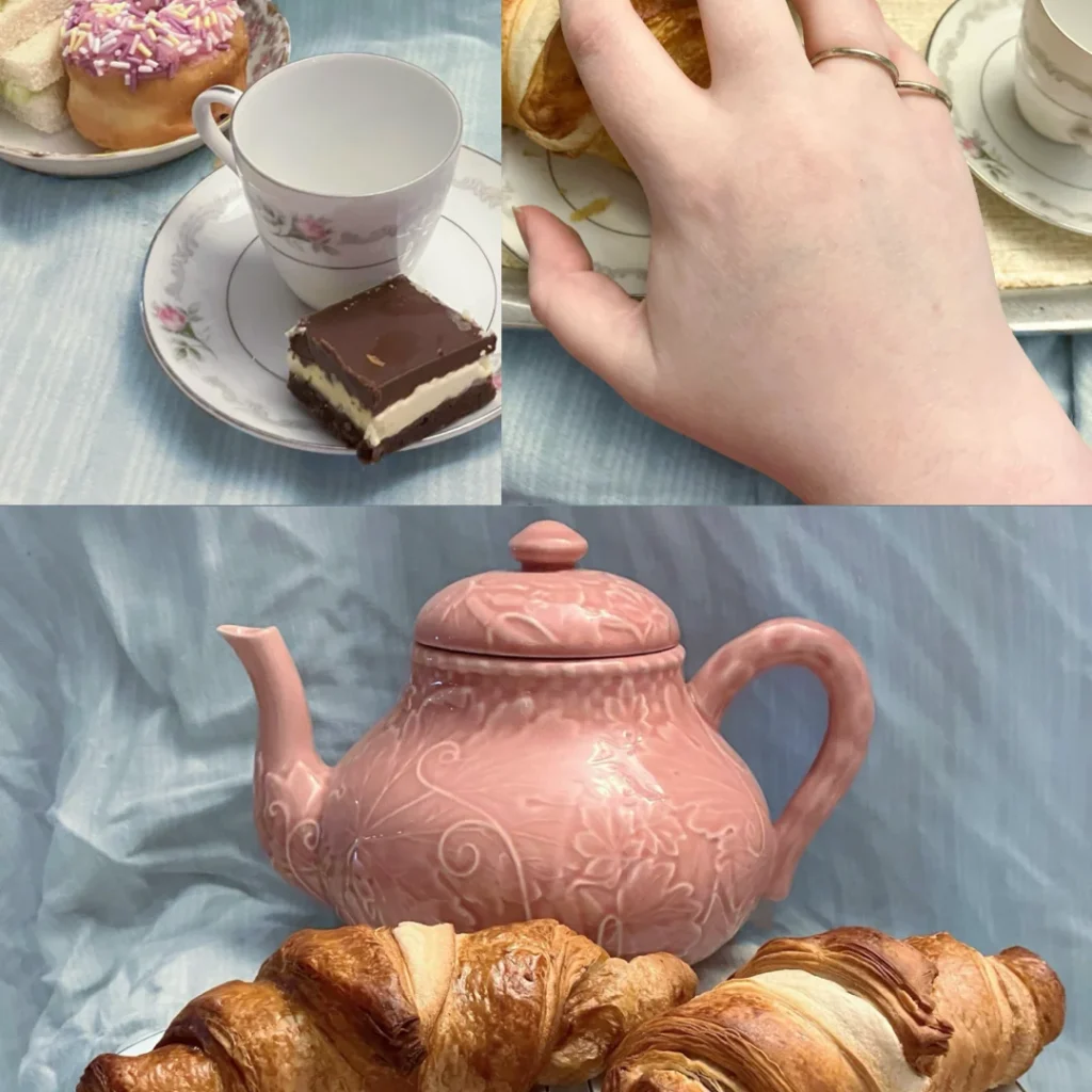 Collage of three home tea party photos against a blue bedsheet, including: 1. A Nanaimo bar on a teacup saucer, near a pink glazed donut and cucumber sandwich; 2. a hand with silver ring splints reaching for a croissant on a tea tray; and 3. an elegant rose-coloured teapot sitting behind two croissants on white plates with rose patterns.